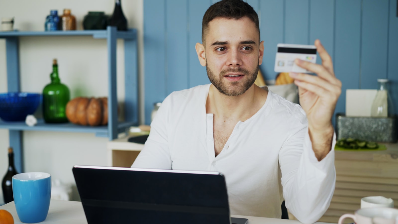 A person completing an online purchase at a kitchen table